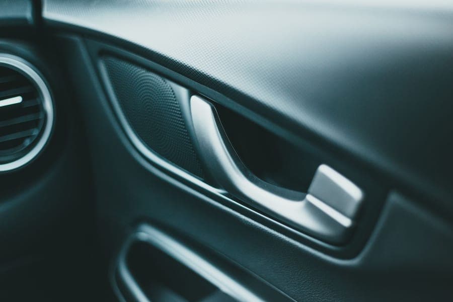 Interior car door panel and door handle photographed close up